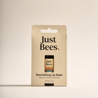Just Bees Nourishing Lip Balm in packaging, made with beeswax and coconut oil for soft, hydrated lips.